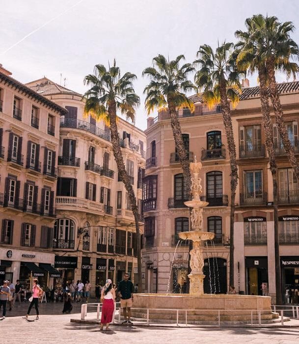 Palm trees and a fountain in a square in Málaga’s historic centre
